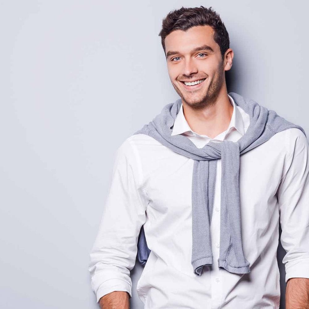 Confident man smiling gently in a close-up shot.