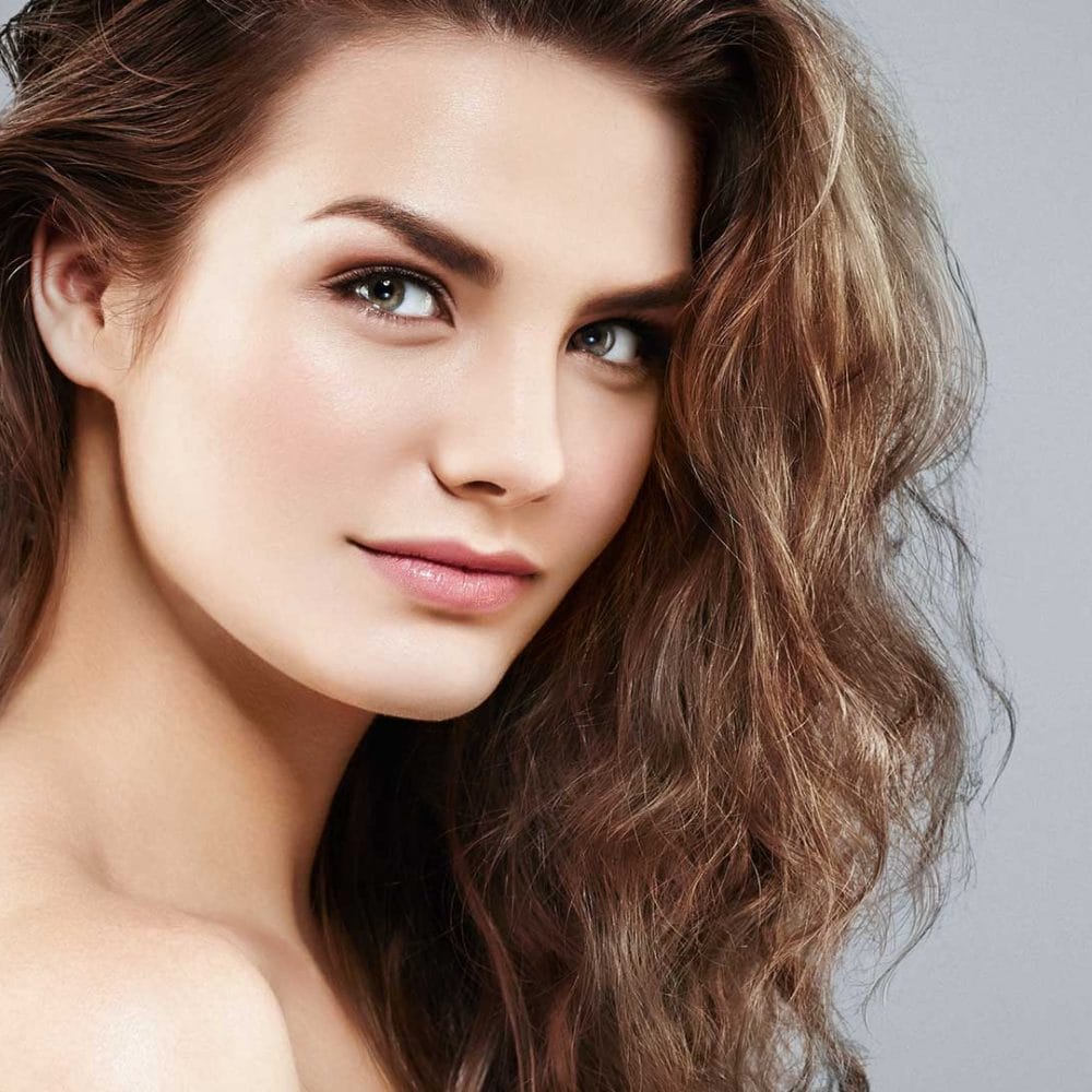 Close-up of a beautiful woman model with gray background.