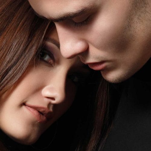Man and woman standing close together, close-up image.